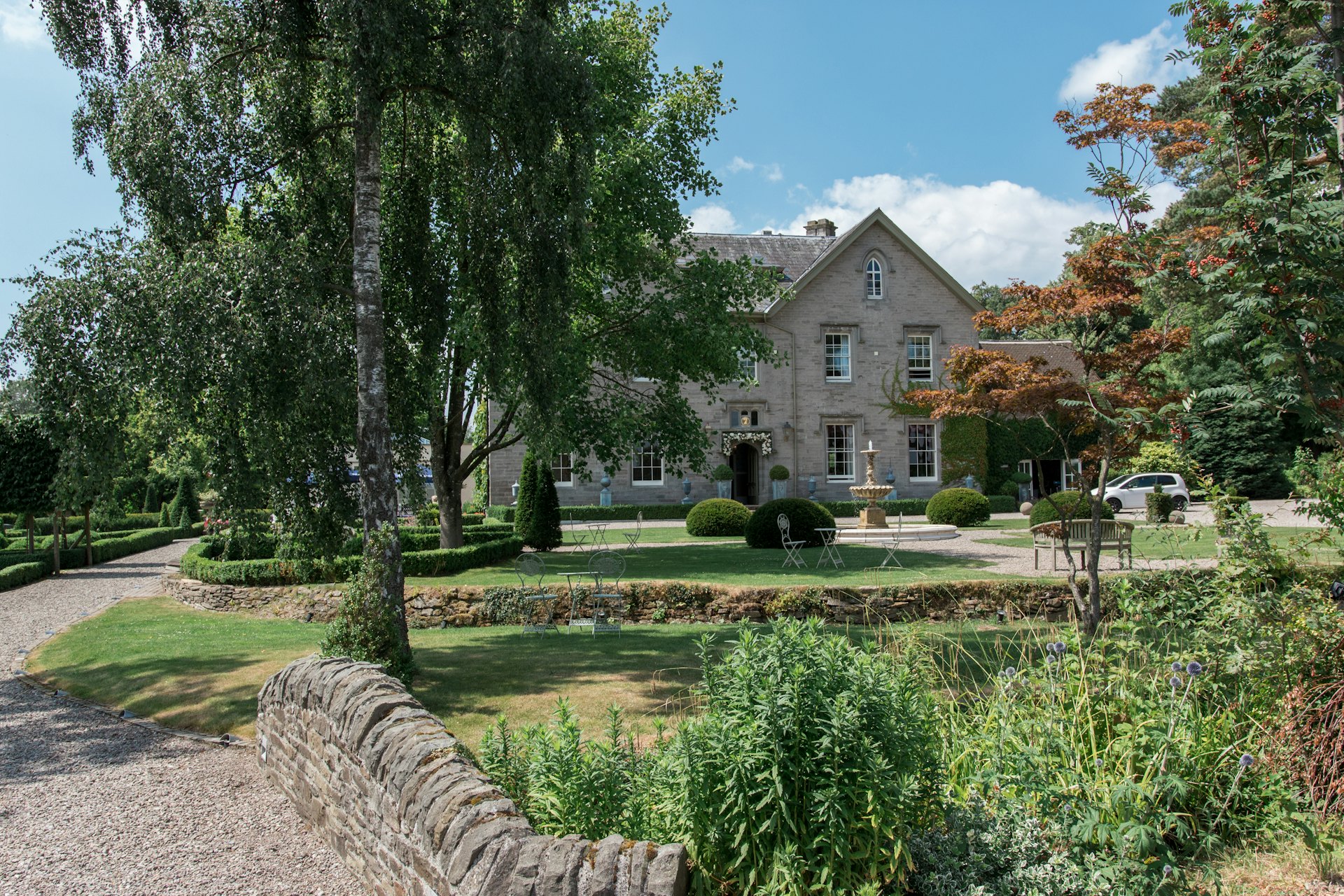 An English country house with lawns and mature trees